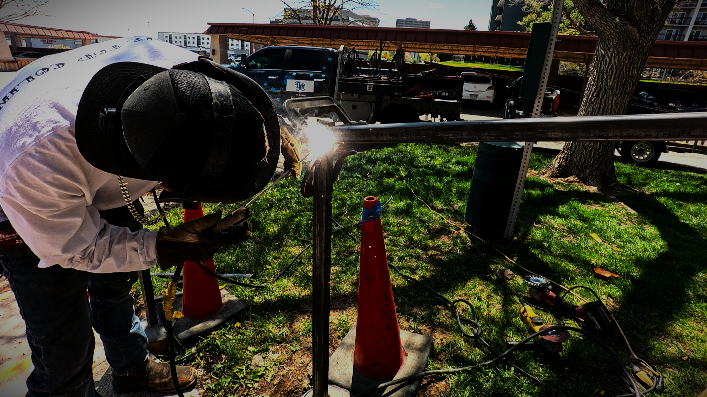 Welder working on metal fabrication project